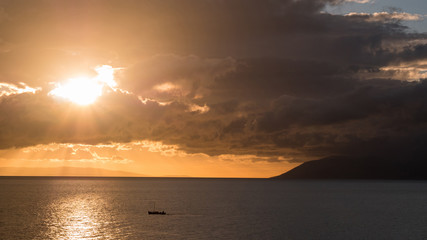 Sunset on sea with large clouds