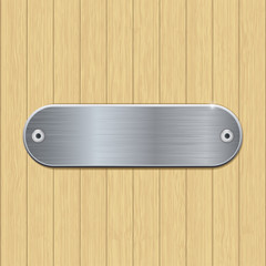 Metal brushed plate on wooden wall