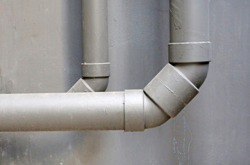 water pipes on cement wall of building