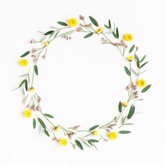 Flowers composition. Wreath made of yellow flowers and eucalyptus leaves on white background. Flat lay, top view