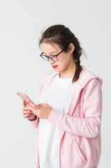 Portrait of beautiful young woman playing her mobile phone.