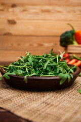 Obraz na płótnie Canvas Green arugula leaves in bowl. Fresh salad.