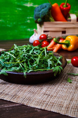 Green arugula leaves in bowl. Fresh salad.