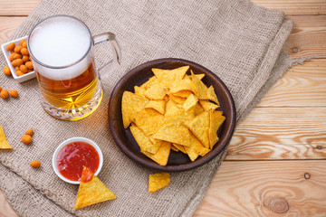 Glass of beer. Nachos chips. Tortilla snack.