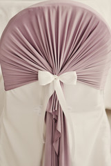 white bow on a white wedding chair in the banquet room