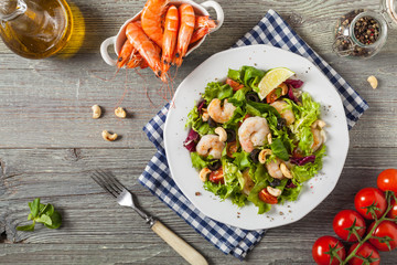 Shrimp salad with tomato, olives and cashew nuts.