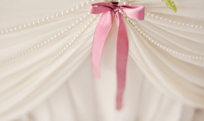 ink bow on a white wedding chair in the banquet room