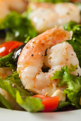 Shrimp salad with tomato, olives and cashew nuts.