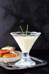 Simple easy to cook milk based gravy in a glass on a metal tray. Healthy food concept