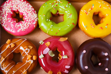 Donuts with icing. Sweet glazed donut. Dessert with sprinkles. Top view.
