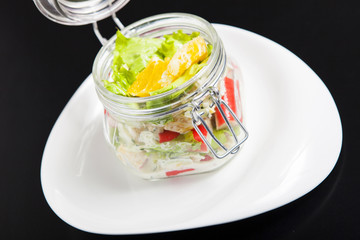 Vegetarian Rainbow salad in a glass jar for summer picnic. Trends in healthy eating.