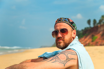 Bearded man on the beach.