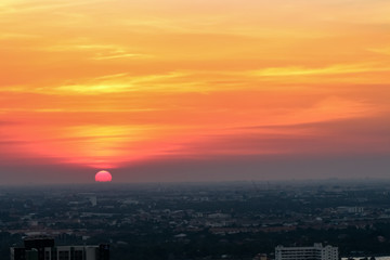 Sunrise sunset in the city with selective focus on the sun