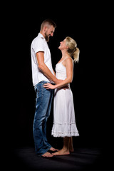 Romantic couple embracing each other in nightly lit atmosphere