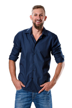 Portrait of tall young man with beard in blue shirt and jeans