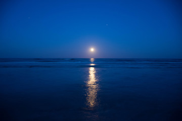 Sunset and the moon rising on the Mediterranean coast in southern Spain