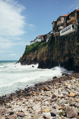 Fototapeta na wymiar Houses at the edge of the cliff above the sea in the old town of Sozopol at Black Sea, Bulgaria. 