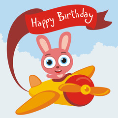 Happy Birthday! Funny rabbit flies on airplane with greeting on red ribbon. Card for birthday with little rabbit in cartoon style.