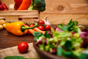 Sweet pepper, brocoli and cherry tomato. Mix salad leaves. Natural raw vegetables. Organic bio food on rustic wooden table.