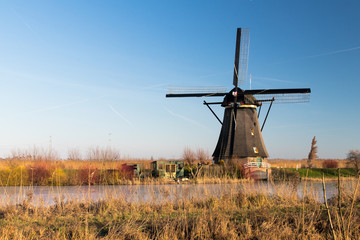 Kinderdijk park in Holland, Netherlands with frozen canals in winter. Windmills and ice in the...