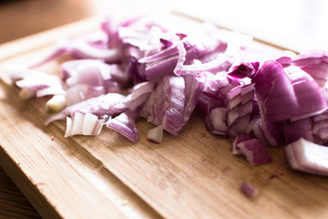 Fototapeta na wymiar Red onions cut on a cutting board, food and spices. Onion slices