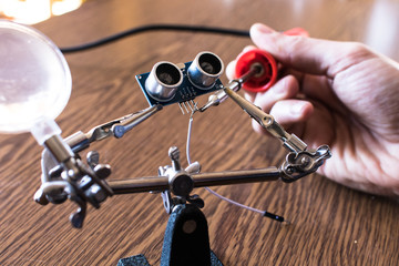 Soldering an ultrasonic sensor. Robotics for kids lesson