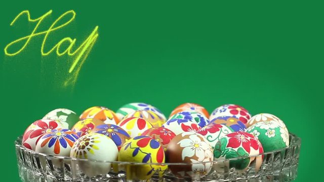 A crystal vase with Easter eggs revolves and above it appears the text "Happy Easter" 