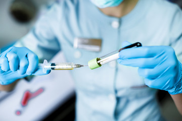 beautician is gaining the blood in syringe from the tube test. Preparation of blood to procedure Plasmolifting