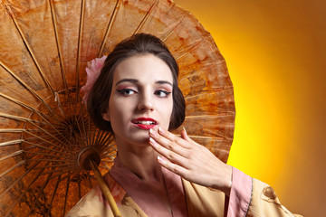 Beautiful woman in traditional japanese kimono with umbrella