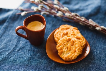 A cup of espresso on a table with cookies