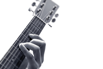 male musician hands playing guitar. black and white, shallow dept of field, focus on forefinger. isolated on white