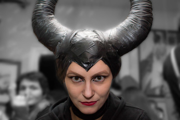 Naklejka premium Novi Sad, Serbia - November 01, 2014: Maleficent - beautiful woman from a fairytale with hair horns and creative make-up for the Halloween party.