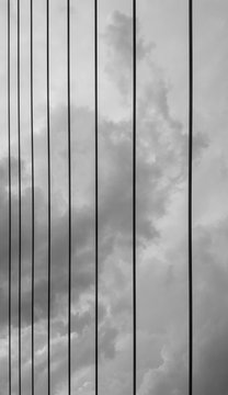Fototapeta Sling of bridge with beautiful sky, hanging structure. Shoot in black and white shot.