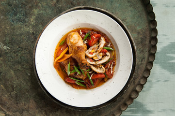a dish of chicken on an old antique tray
