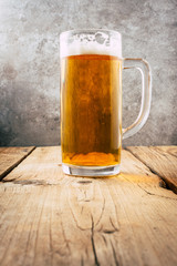 Glass of beer on wooden table. wallpaper with copy space