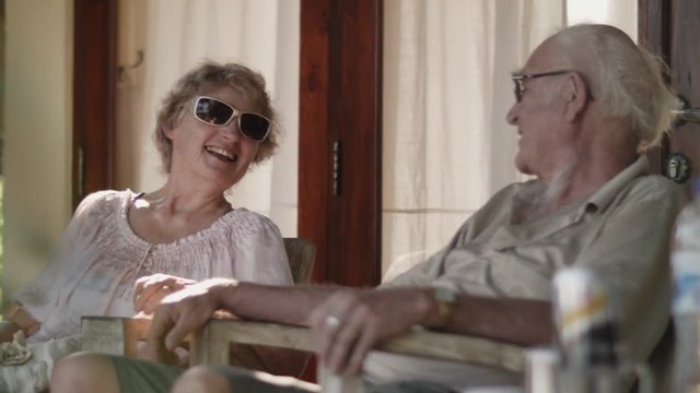 Seniors couple sitting in the courtyard and relaxing