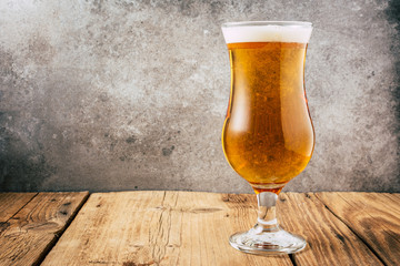 Glass of beer on wooden table. wallpaper with copy space