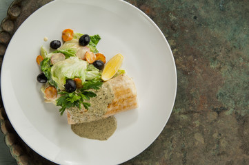 salad with olives on an old antique tray