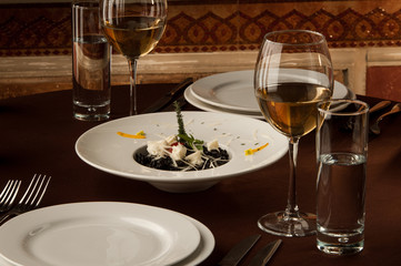 served table with glasses of wine on the background of painting