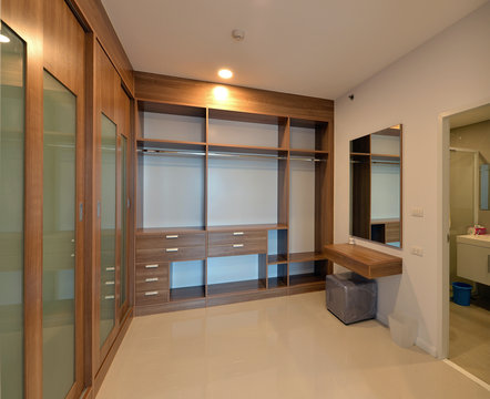 wooden carbinets in dressing room in modern home, interior design