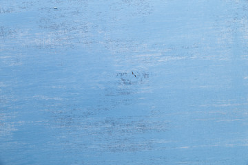 Blue wood background. Painted scraped wooden board. Grunge plywood texture or pattern.