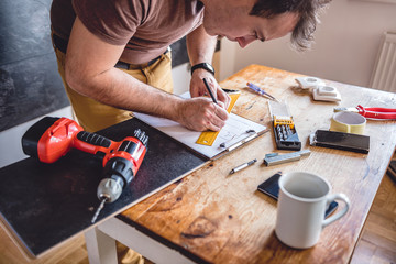 Man making draft plan using pencil