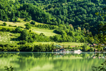 Fototapeta na wymiar Landscape with green hills and the river Drina, which flows from the mountains