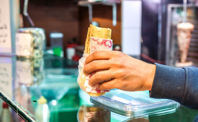 Fototapeta na wymiar Shawarma as best street food in man hand