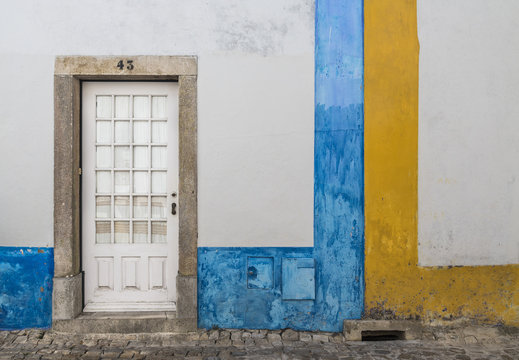 A colorful painted wall of a house in the ancient fortified village of Obidos Oeste Leiria District Portugal Europe
