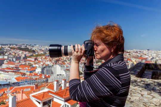 Lisbon. A woman takes pictures of the city.