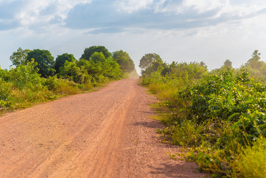 Empty dusty dirt road in rural Cambodia in Kampot province