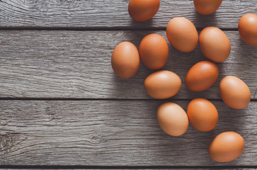 Brown and white organic eggs on wood background