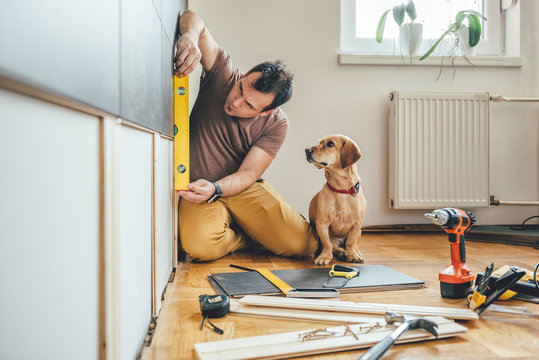 Man and his dog doing renovation work at home