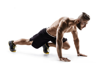 Young man doing stretching and warming up exercises. Photo of muscular man on white background. Sports